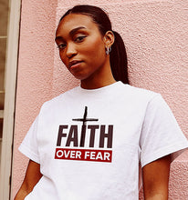 Load image into Gallery viewer, A young woman in a Faith Over fear t shirt.