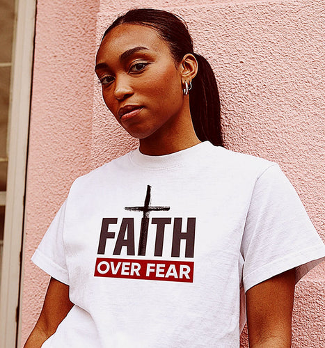 A young woman in a Faith Over fear t shirt.
